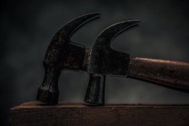 close up picture of two carpentry hammers for craftsmanship concept and wood work 