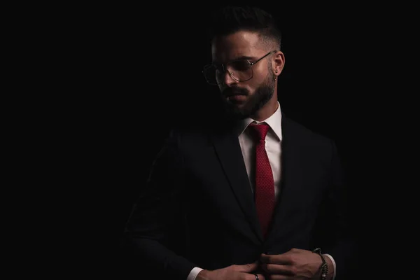 Portrait Bearded Businessman Glasses Unbuttoning Black Suit Looking Side Mysterious — Stock Photo, Image