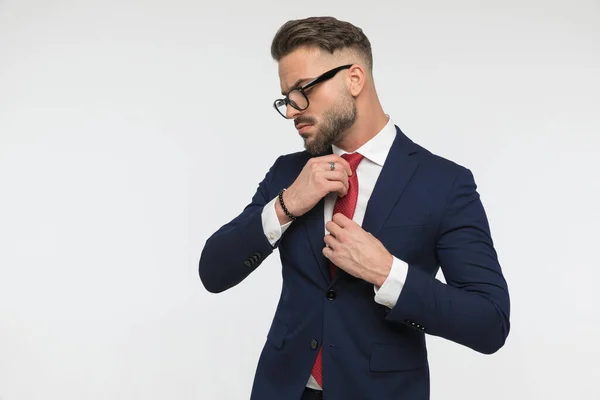 Sexy Stylish Businessman Beard Looking Side Adjusting Tie While Posing — стоковое фото