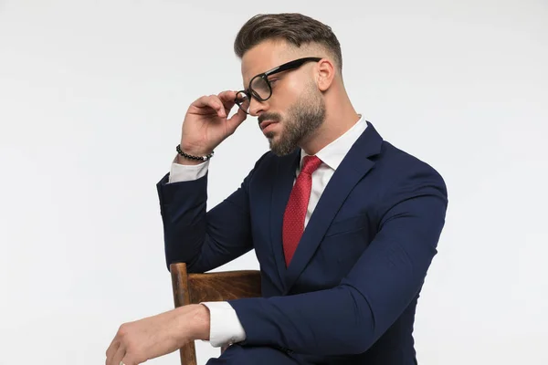 Sexy Bearded Businessman Elbow Chair Looking Side Fixing Eyeglasses While — стоковое фото