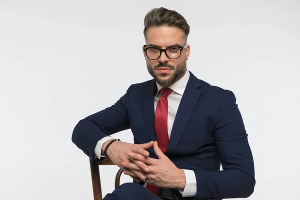 Sexy Businessman Beard Holding Elbows Wooden Chair Posing Confident Manner — стоковое фото