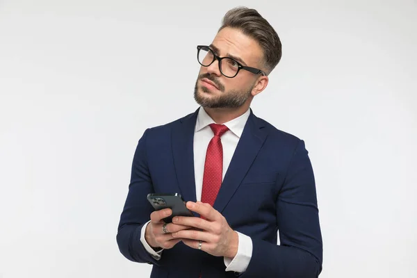 Joven Sosteniendo Teléfono Mirando Hacia Arriba Pensando Cómo Responder Correo — Foto de Stock