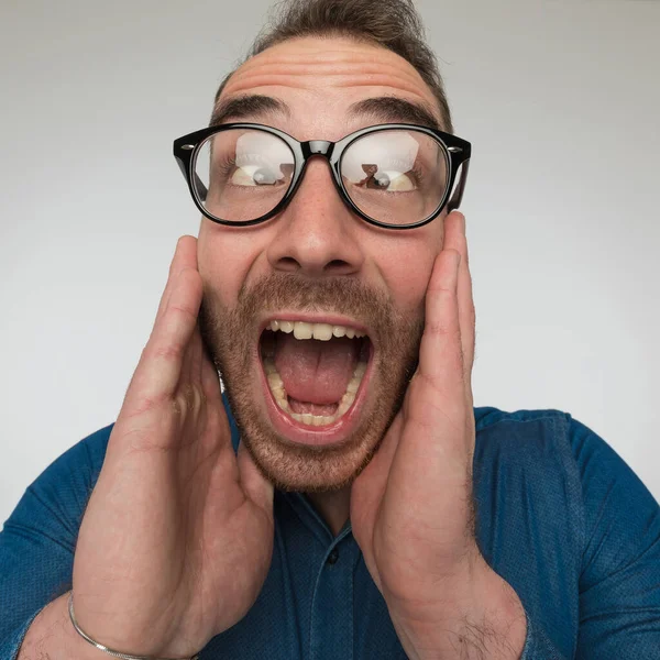 Young Casual Man Out His Mind Wearing Blue Shirt Eyeglasses — Stock Photo, Image