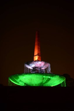 A night view of a fountain lit up in Indian flag colours outside Indias Presidential Residence or Rastrapati Bhavan in New Delhi India