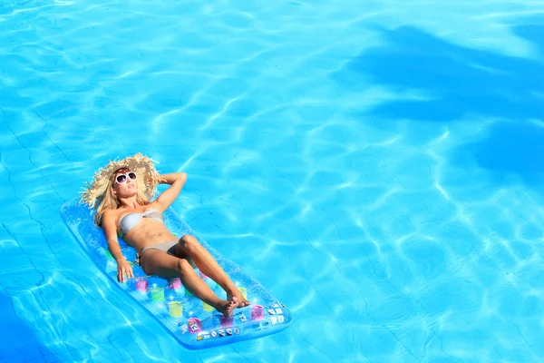 Mulher relaxante em uma piscina — Fotografia de Stock