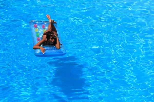 Mulher relaxante em uma piscina — Fotografia de Stock