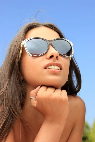 Hübsche Frau mit Sonnenbrille am Strand — Stockfoto