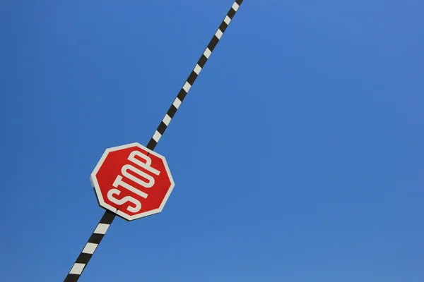 Red stop sign on a barrier Stock Photo