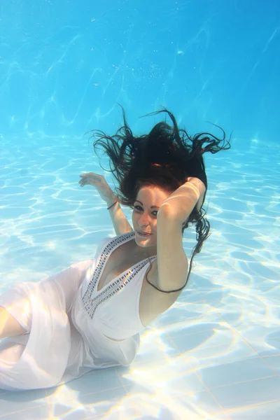 Woman wearing a white dress underwater Stock Photo