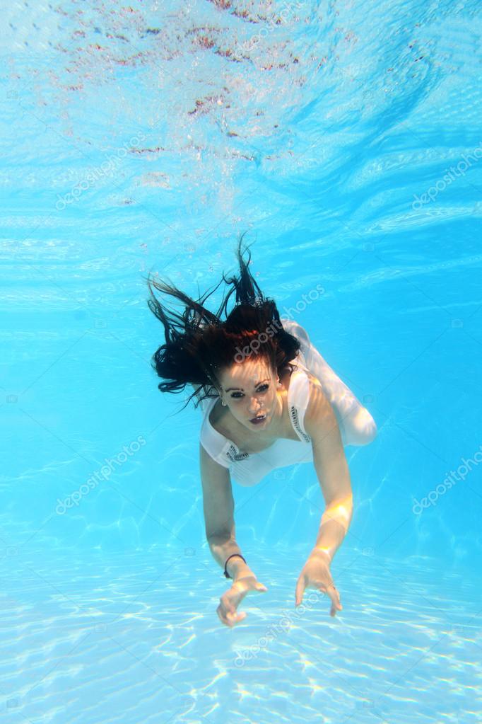 Woman wearing a white dress underwater — Stock Photo © netfalls #12463099