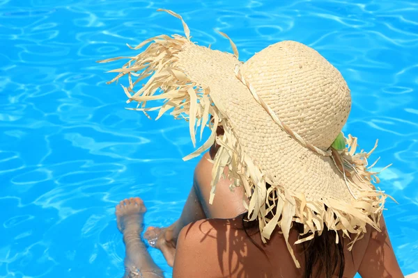 Mulher sentada na borda da piscina . — Fotografia de Stock