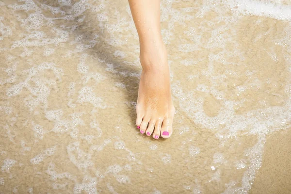 Nice legs of a girl walking in water — Stock Photo, Image