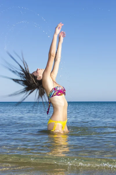 Brunette in the water waving hair Stock Picture