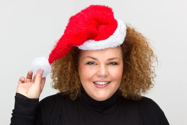 Beautiful young woman wearing a Santa hat — Stock Photo, Image