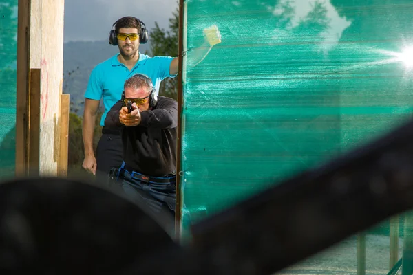 Hombre disparando en un campo de tiro al aire libre — Foto de Stock