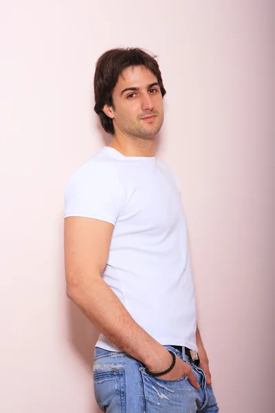 Young man against pink background — Stock Photo, Image