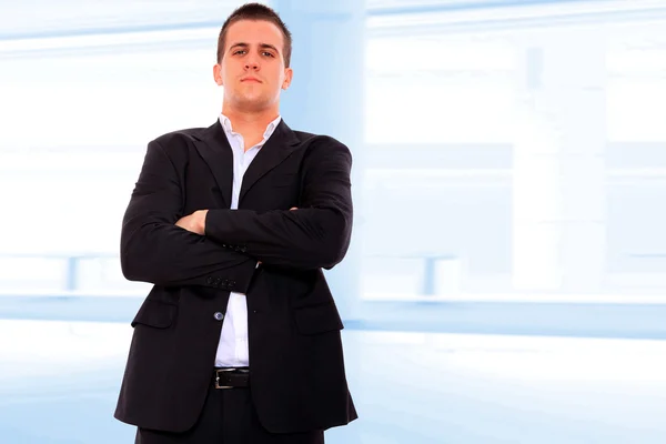 Closeup of a young smiling business man standing — Stock Photo, Image