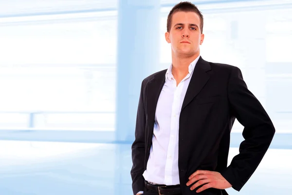 Closeup of a young smiling business man standing — Stock Photo, Image