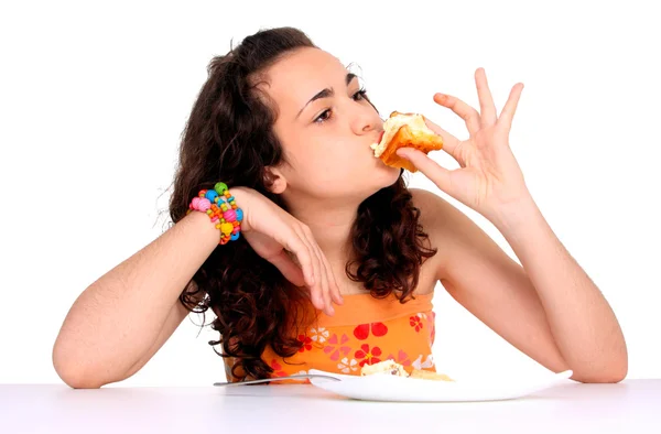 Kobieta jedząca babeczki — Zdjęcie stockowe