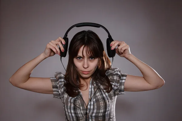 Beautiful women listening music in headphones — Stock Photo, Image