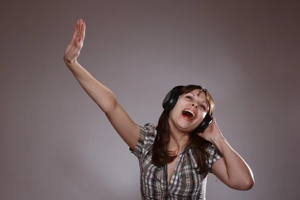 Beautiful women listening music in headphones — Stock Photo, Image