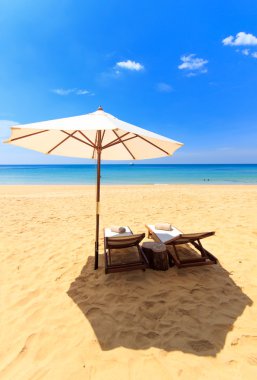 yatak ve bir plaj şemsiye
