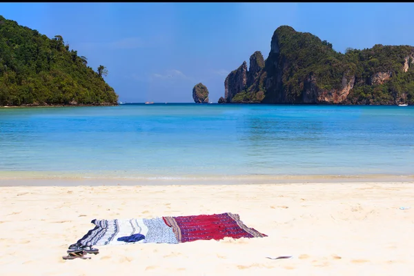 Beach sarong on golden sandy beach — Stock Photo, Image