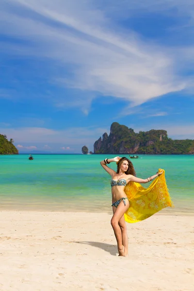 Young woman with sarong on the beach — Stock Photo, Image