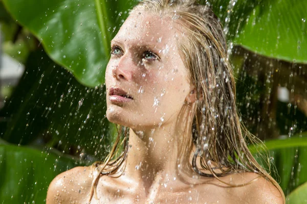 Woman in tropical shower — Stock Photo, Image