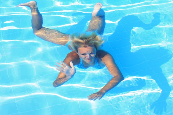 Fille nager sous l'eau dans une piscine — Photo