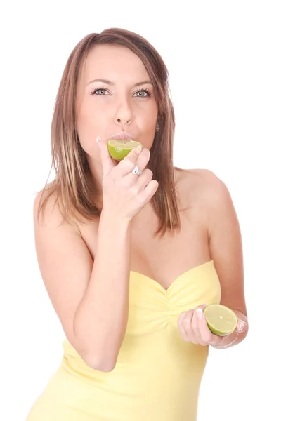 Happy model eating lime — Stock Photo, Image