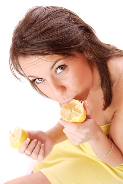 Young woman eating sour lemon Royalty Free Stock Images