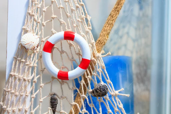 Fishing net with buoy and shell — Stock Photo, Image