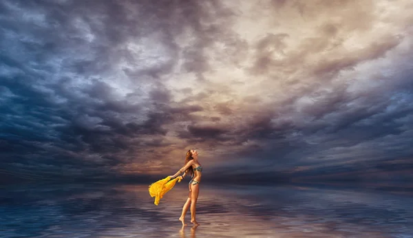 水の上を歩いてサロンを持つ女性 — ストック写真