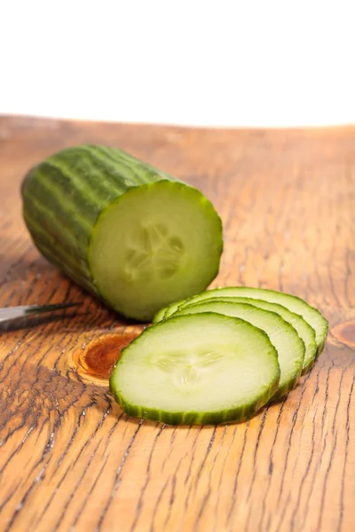 Big cucumber sliced on a wood table — Stock Photo, Image