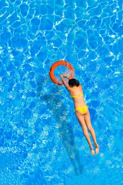 Jumping in the buoy at the swimming pool — Stock Photo, Image