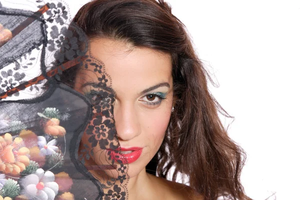 Spanish woman behind traditional fan. — Stock Photo, Image