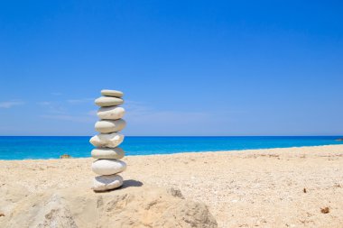 Pebbles stack balance over blue sea