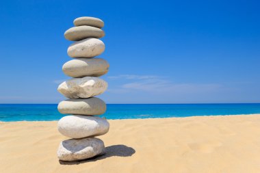 Pebbles stack balance over blue sea