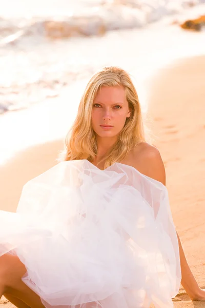 Woman wrapped in wedding veil on the beach Royalty Free Stock Images