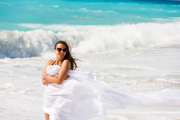 Meisje met witte sarong op het strand. — Stockfoto