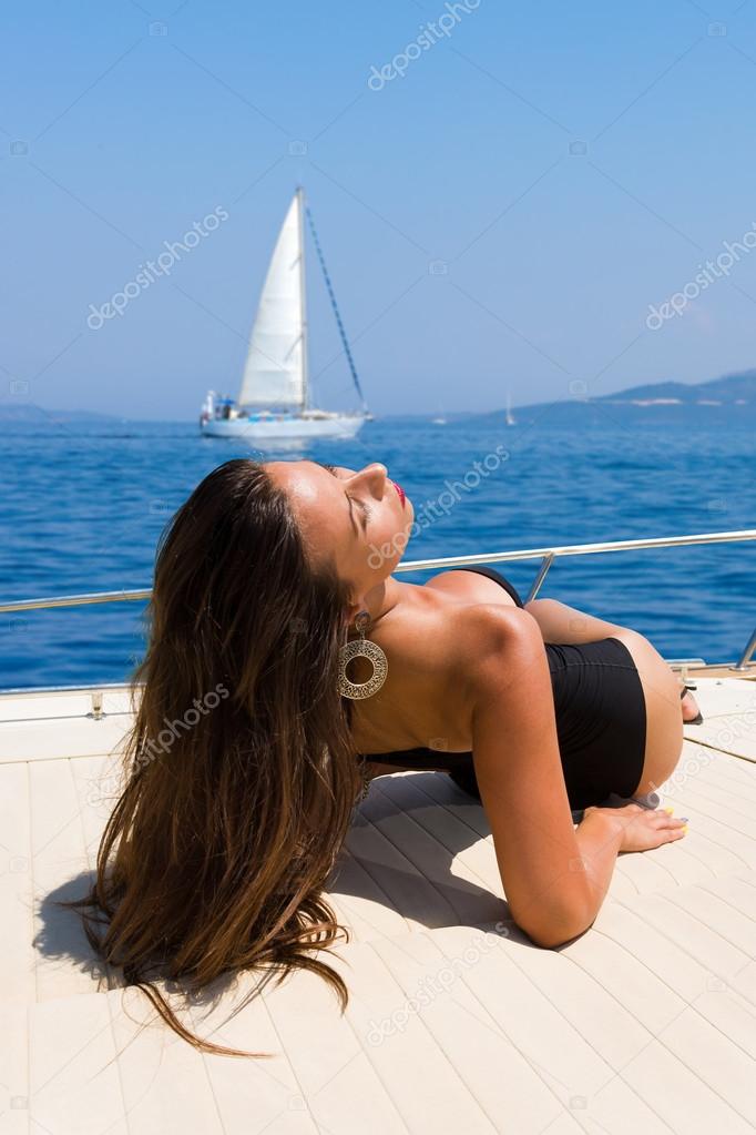 Young woman on her private yacht