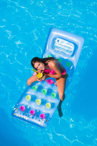 Une fille se relaxe dans une piscine — Photo