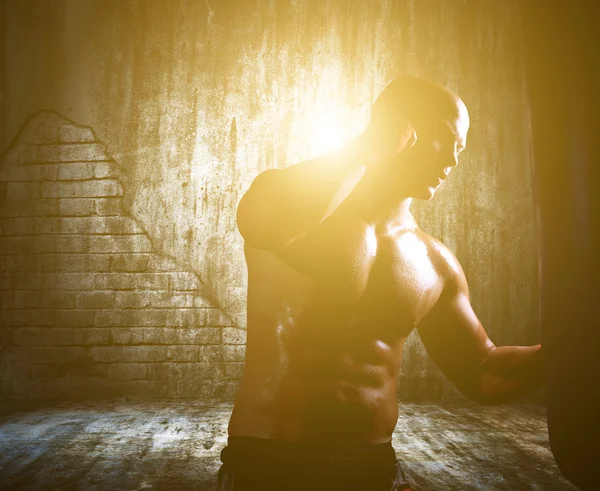 Boxer man during boxing hiting heavy bag — Stock Photo, Image