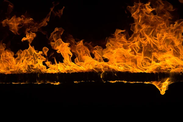 Lodernde Flammen auf schwarzem Hintergrund — Stockfoto