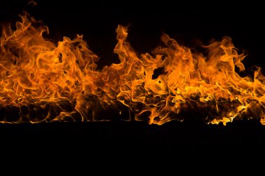 Blazing flames on black background clipart