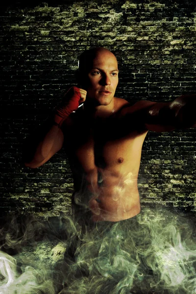 Boxer man during boxing hiting heavy bag at training fitness — Stock Photo, Image