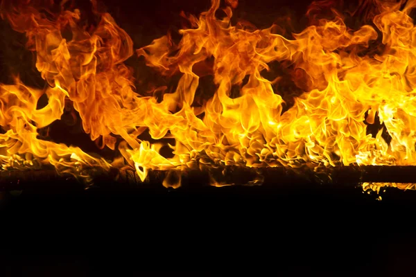 Blazing flames on black background — Stock Photo, Image