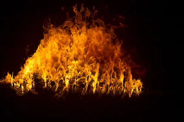 Blazing flames on black background — Stock Photo, Image