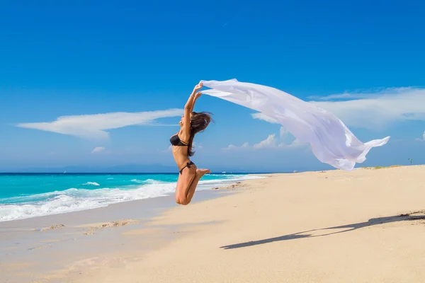 Bella ragazza con tessuto bianco sulla spiaggia . — Foto Stock